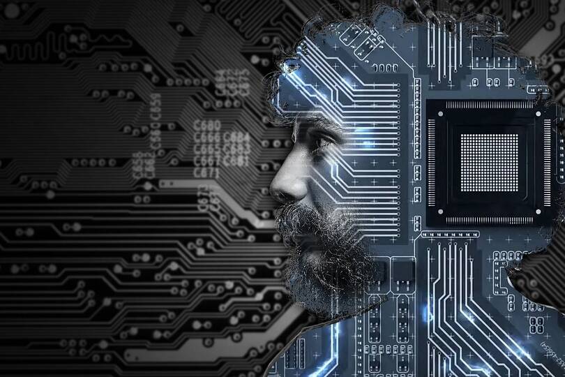 Homem com cabelo e barba, perfil iluminado por circuitos eletrônicos e chip, simbolizando tecnologia e inovação.